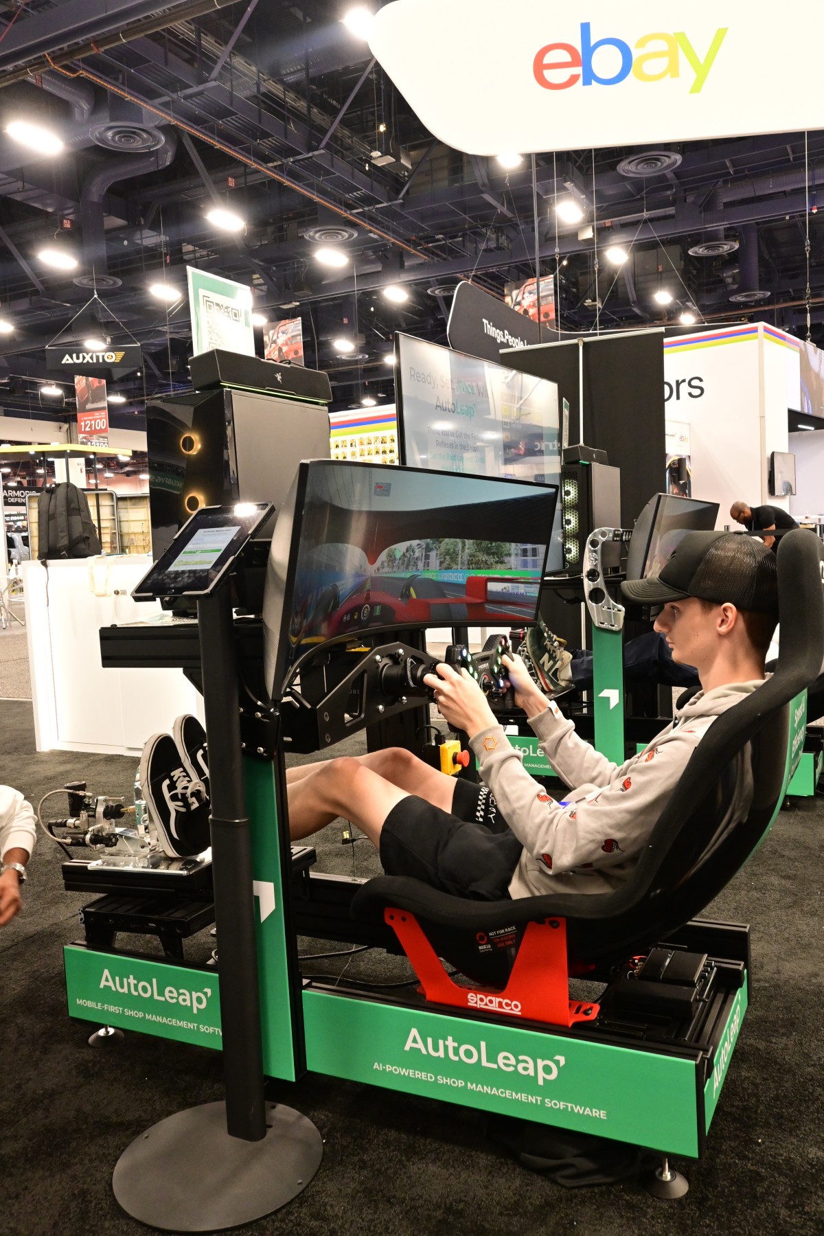 SEMA 2025 attendee racing on the AutoLeap F1 simulator rig