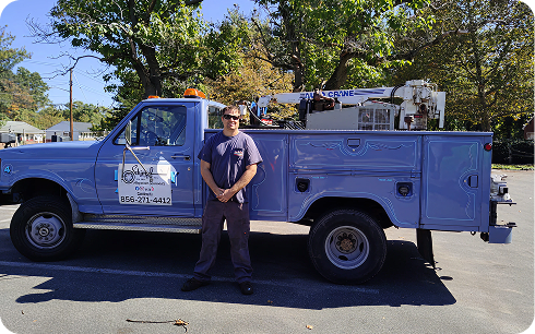 Abe's Auto Mobile Mechanic standing beside a service utility truck